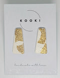 Pair of gold and white  handmade polymer clay earrings  on a Kooki branded card.